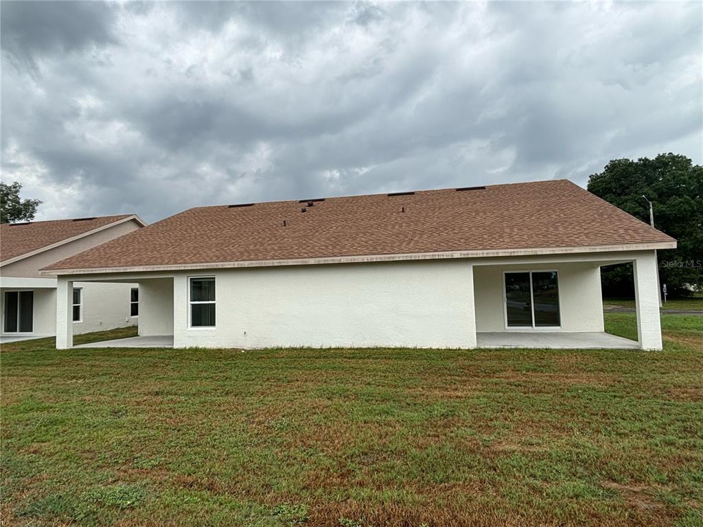 4058 Oak Loop, Unit 99 Mulberry, FL 33860 - Photo 1 of 13 a front view of house with yard