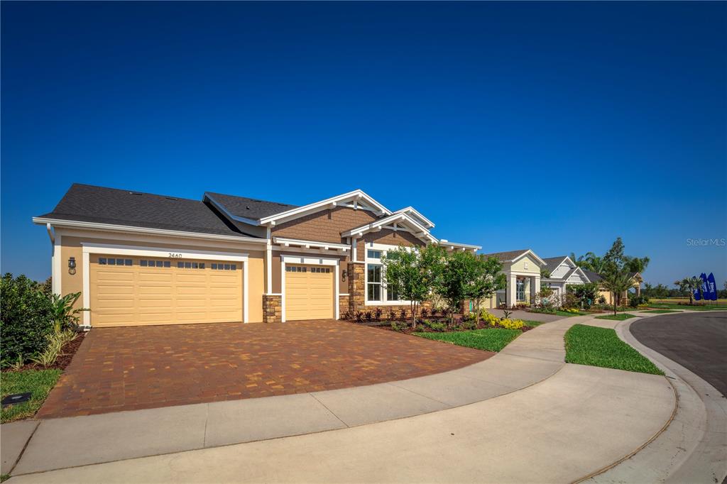 2460 Dream Home Court St. Cloud, FL 34772 - Photo 1 of 45 a front view of a house with a yard and garage