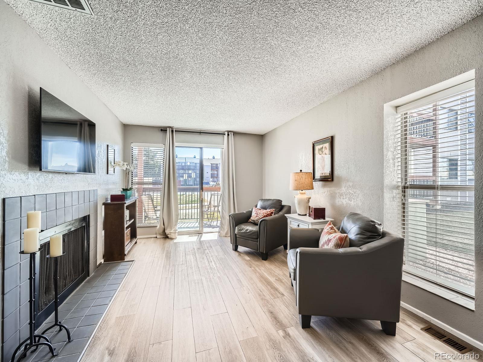 2740 West 86th Avenue, Unit 178 Westminster, CO 80031 - Photo 1 of 15 a living room with furniture and a flat screen tv